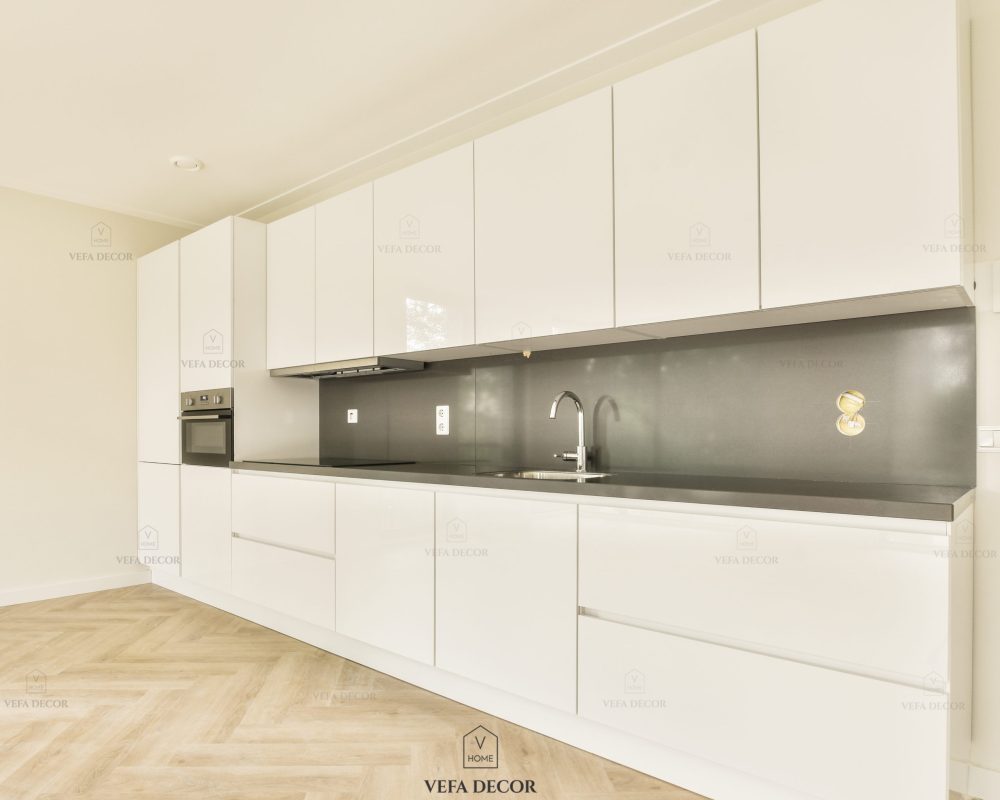 Interior of empty white kitchen with windows and wooden parquet floor