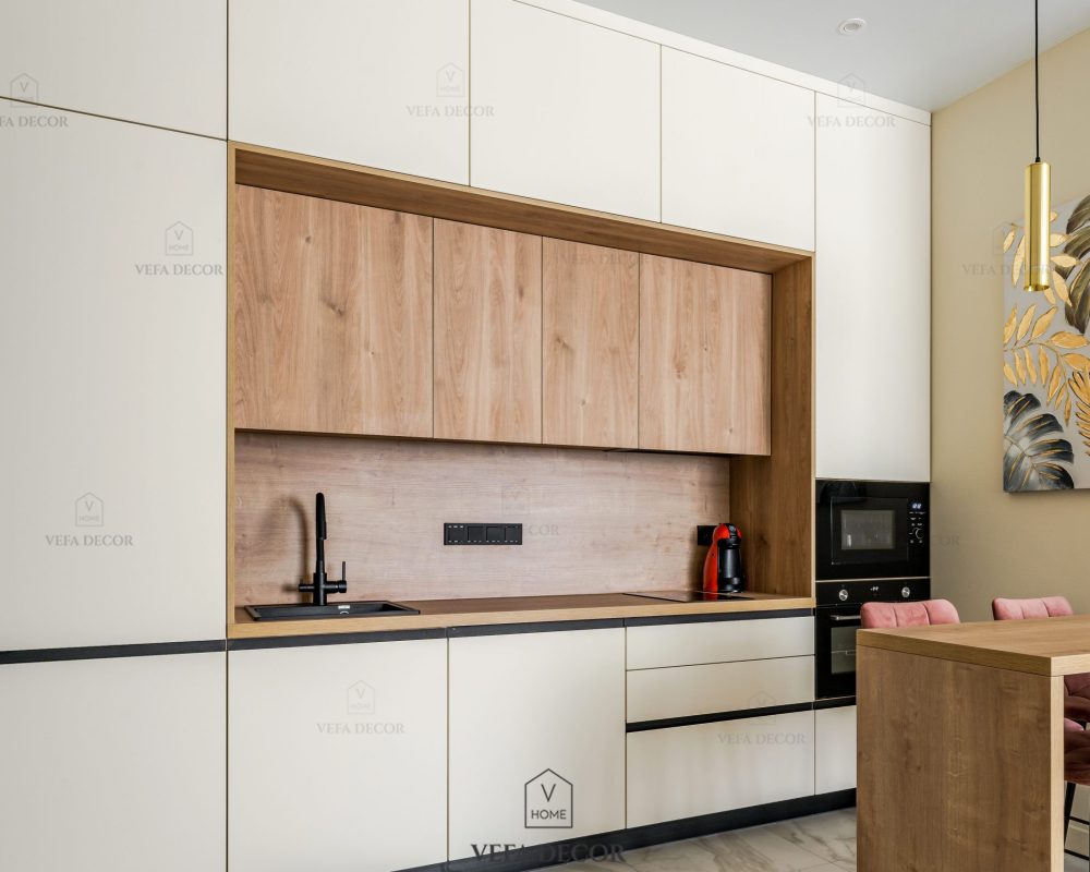 Moscow, Russia - June 8, 2024: Stylish kitchen with beige furniture . Minimalistic cream-colored kitchen with equipment in a modern apartment. Kitchen set with a bar counter and four bar stool.