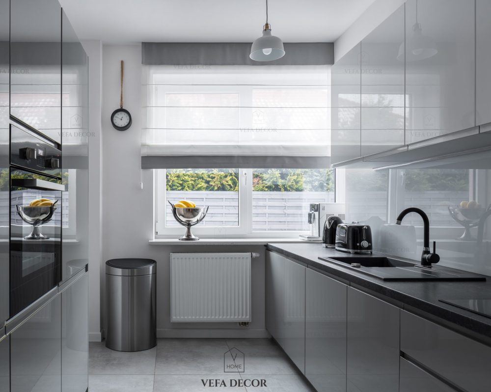 Narrow kitchen with window and modern, gray furniture